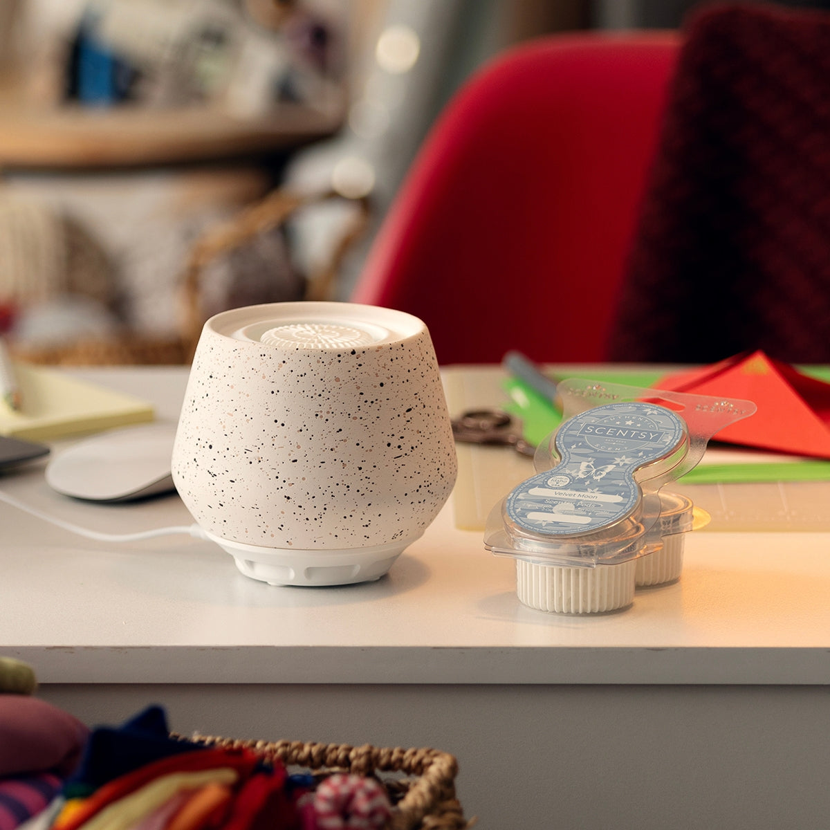 Speckled white diffuser on a surface with packaging in the background
