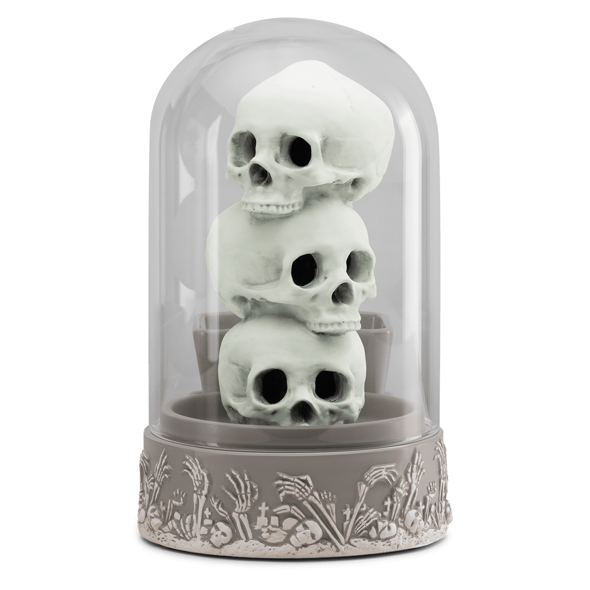 Decorative display with stacked skulls inside a glass dome on a green background