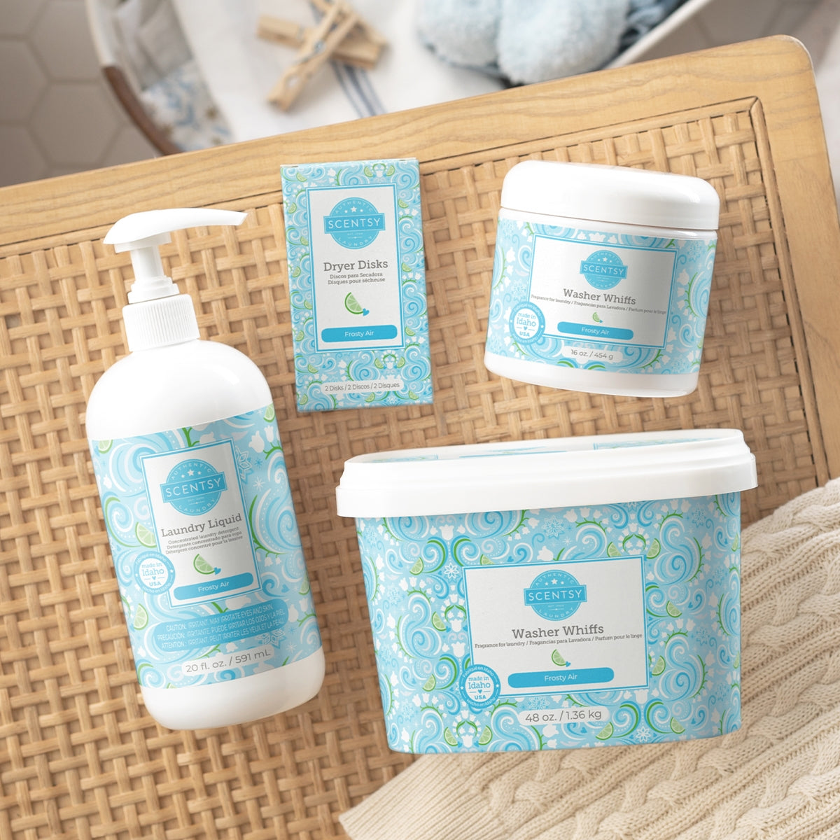 Set of laundry products including bottles and containers on a woven surface.