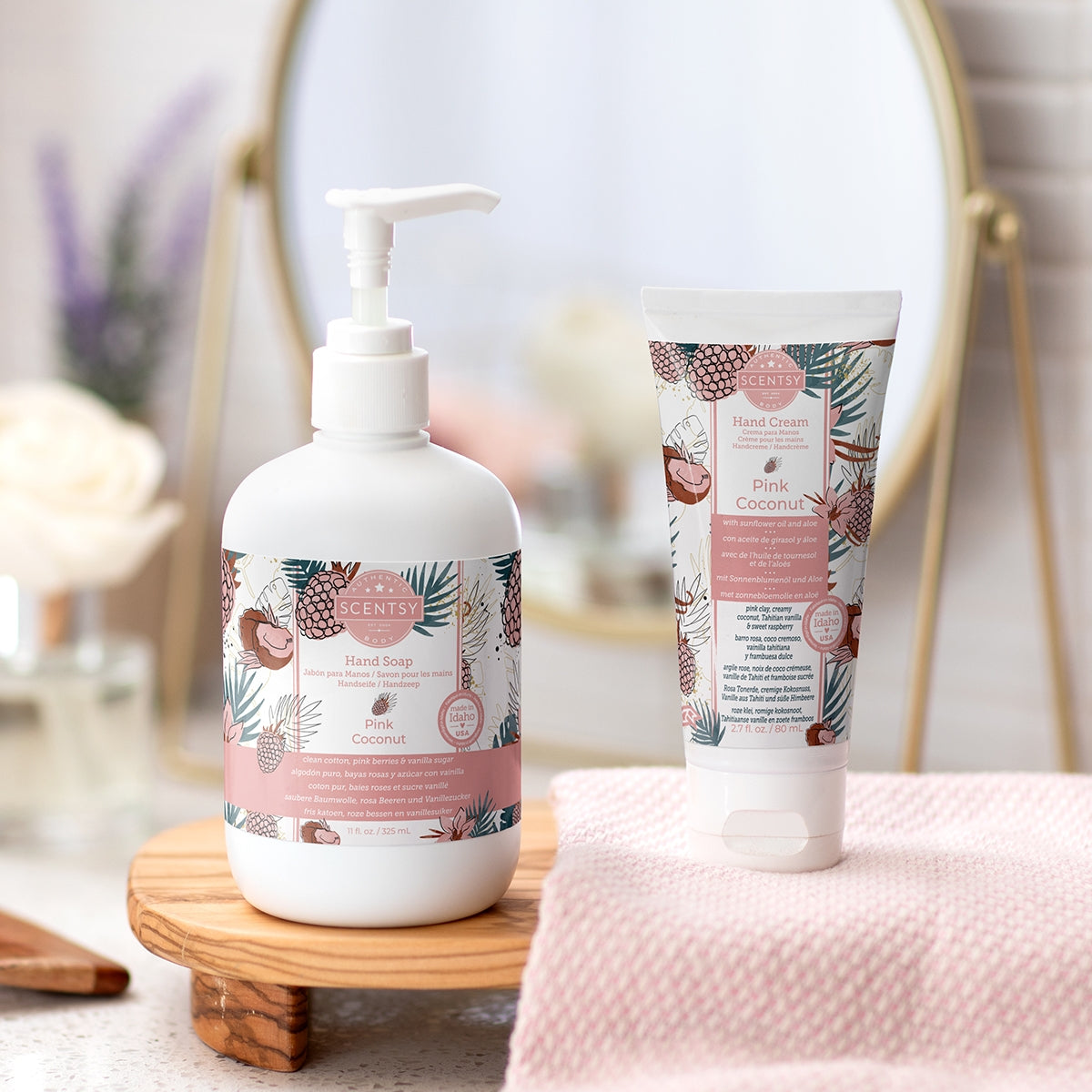 Hand soap bottle and tube with floral design on a wooden stand.