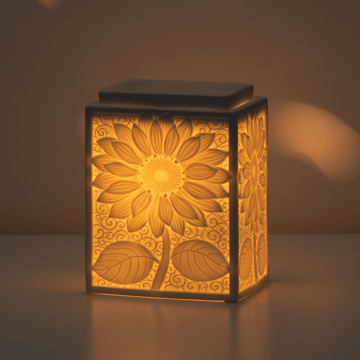 Decorative lamp with sunflower design on a dark background