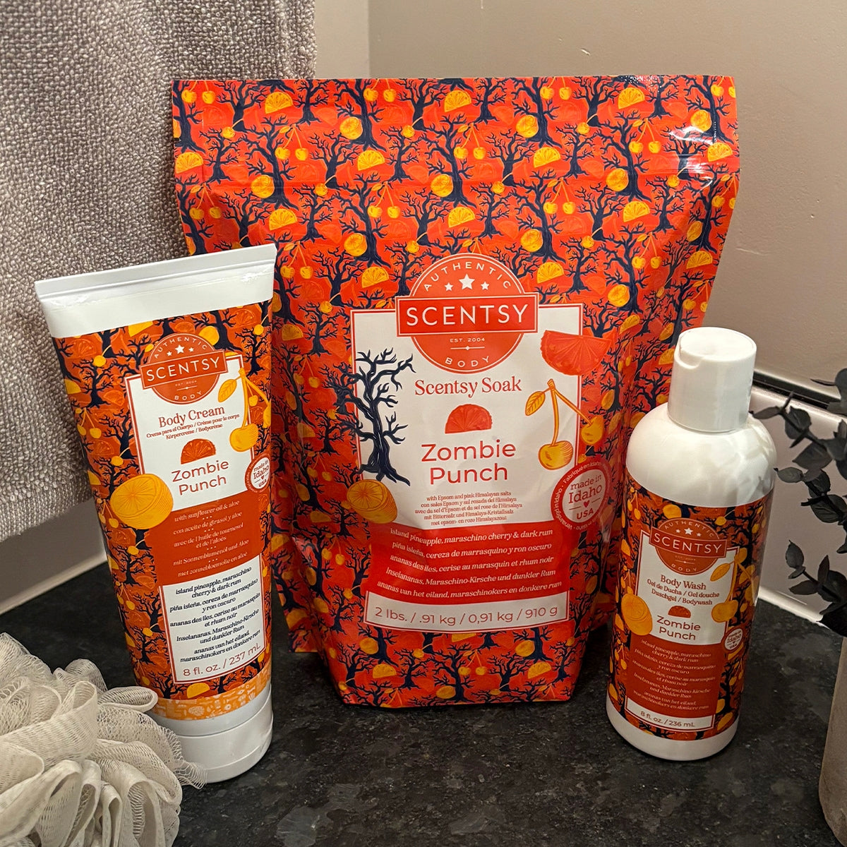 Scentsy Zombie Punch products including a bar of soap, lotion, and body cream on a dark surface.