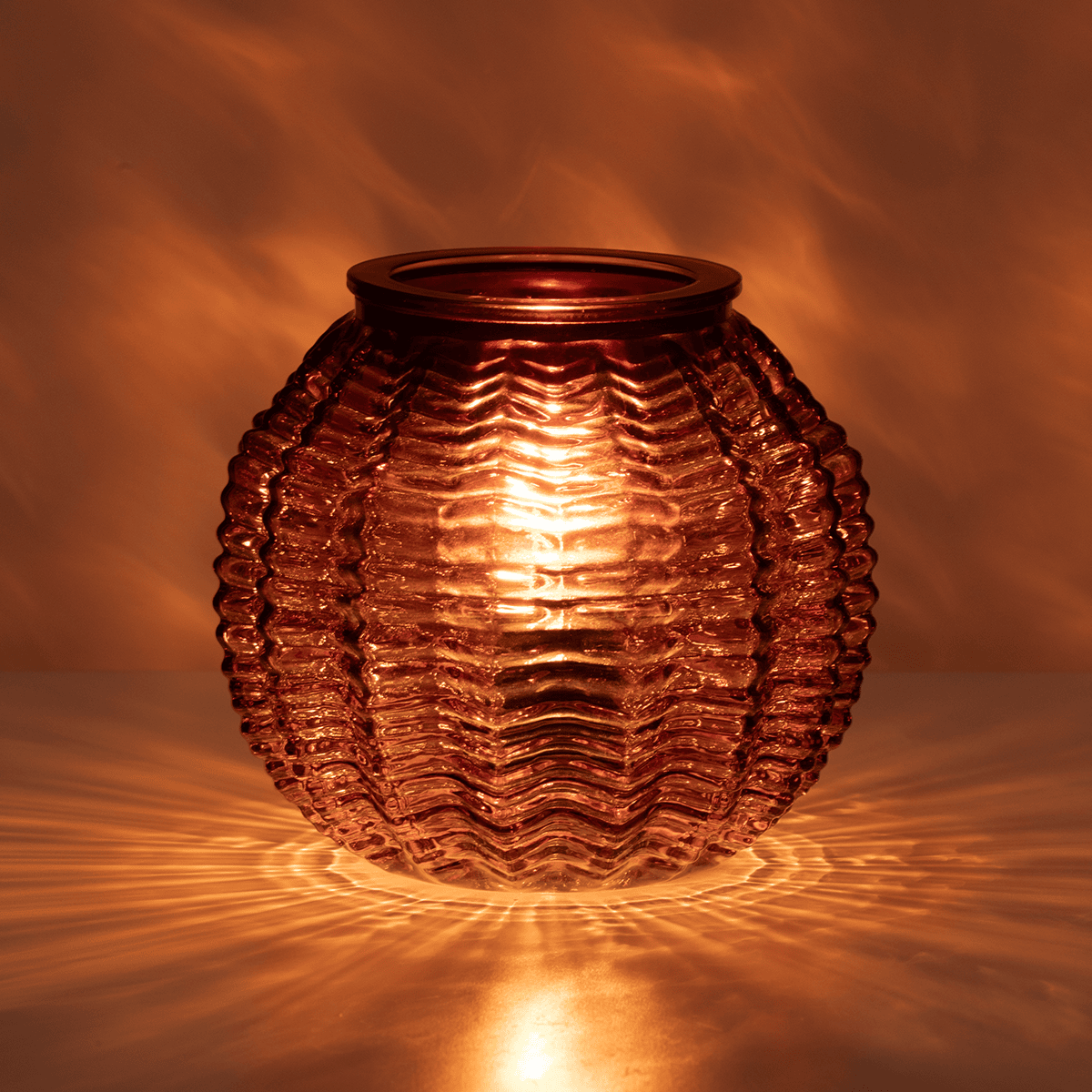 Decorative glass lantern with wavy texture on a warm brown background