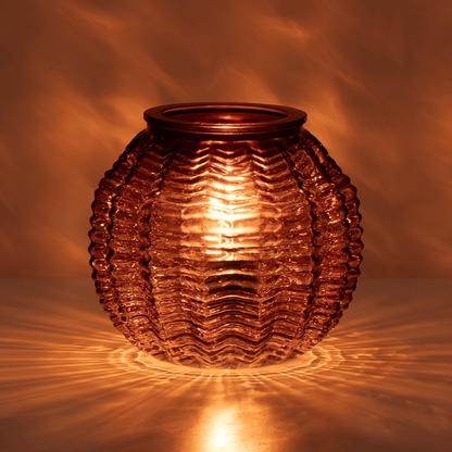 Decorative glass lantern with wavy texture on a warm brown background