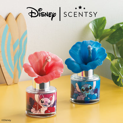 Two Scentsy products with floral designs and Disney characters on a yellow surface.