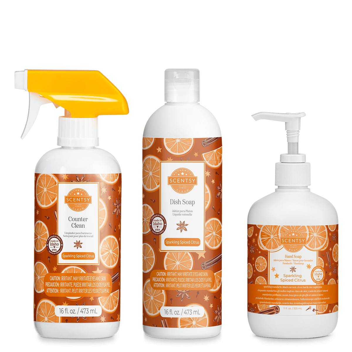 Set of Scentsy products including a spray bottle, dish soap, and hand soap with orange and cinnamon design on a green background.