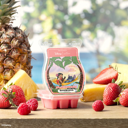 Packaged product with a tropical design surrounded by fruits on a wooden surface.