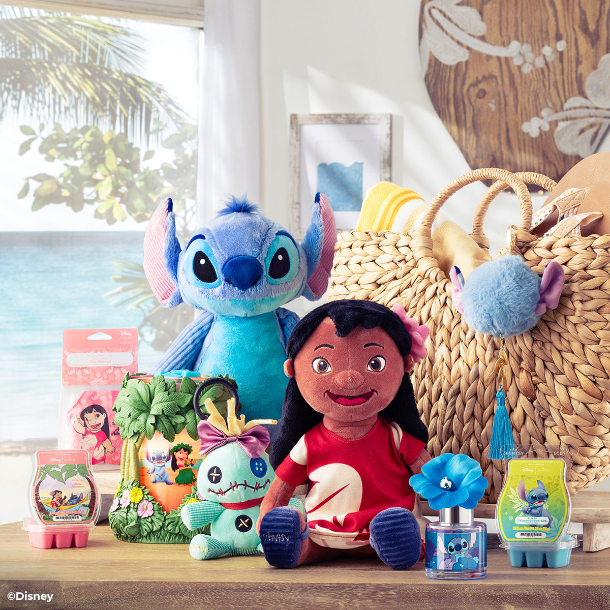Disney-themed toys and products on a table with a beach view in the background