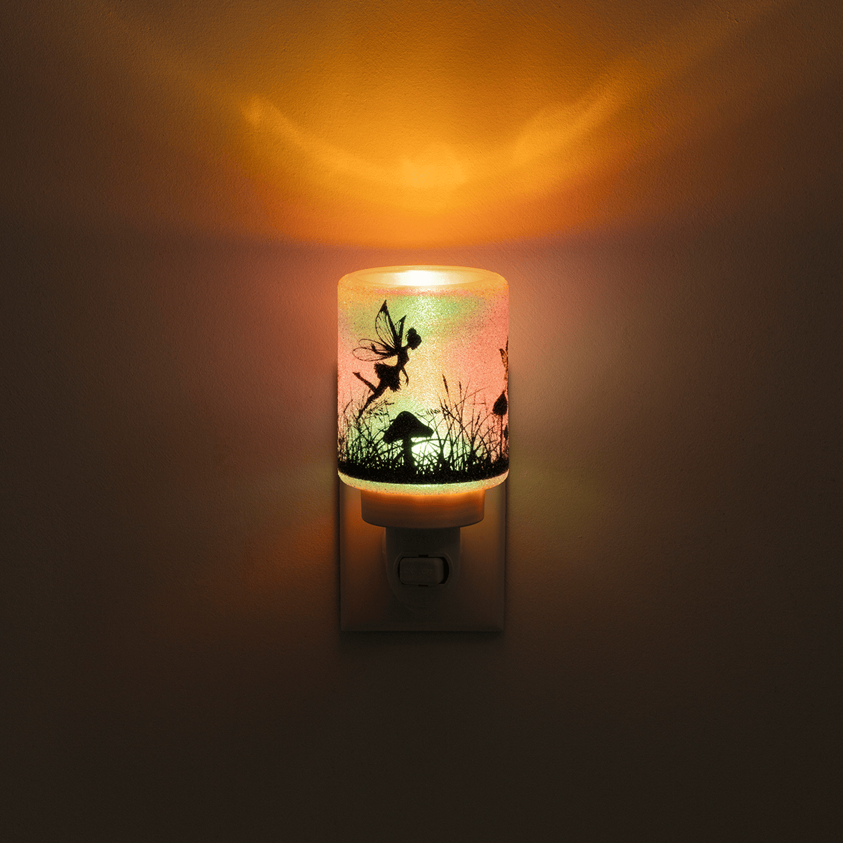 Decorative night light with fairy design on a dark background