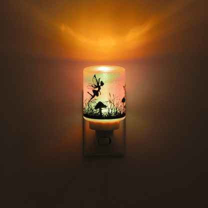 Decorative night light with fairy design on a dark background