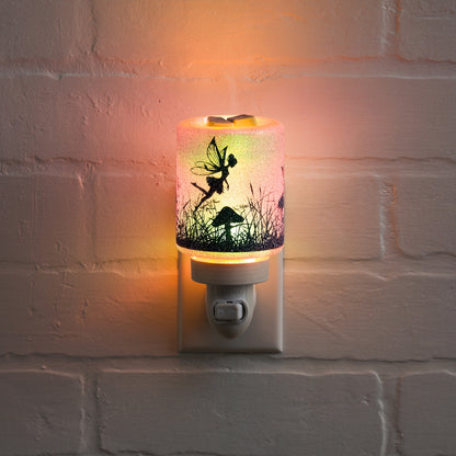 Decorative night light with fairy design on a white brick wall