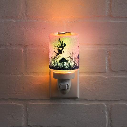 Decorative night light with fairy design on a white brick wall