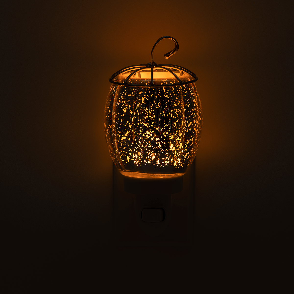 Decorative night light with a glowing interior on a dark background