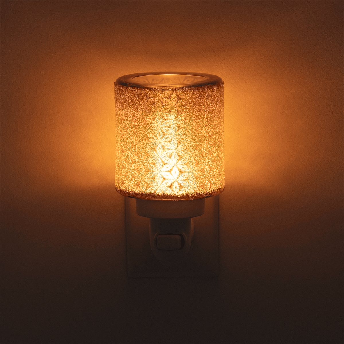 Decorative night light with textured glass罩and warm glow on a dark background