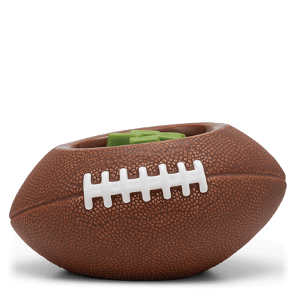 Brown football-shaped dog toy on a black stand with a white background