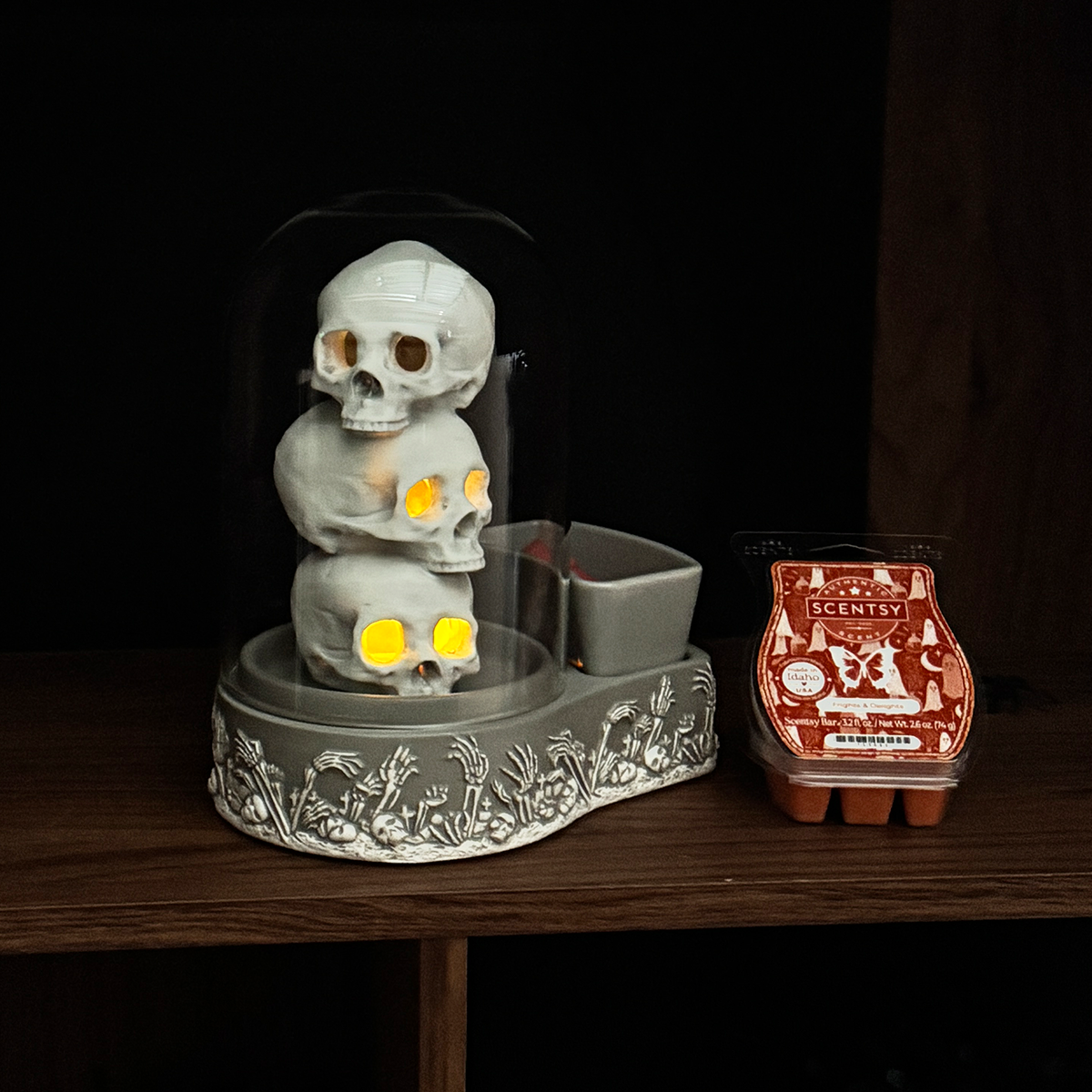 Decorative skull-shaped diffuser with Scentsy packaging on a wooden surface