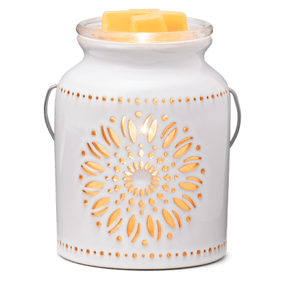 White ceramic warmer with decorative patterns on a white background