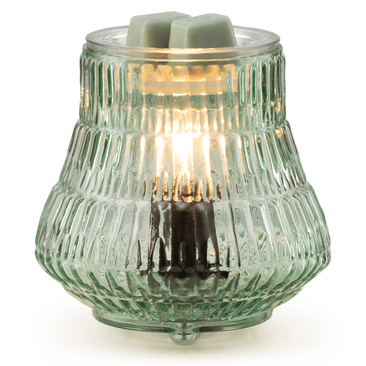 Decorative glass lamp with a light bulb inside on a white base against a green background