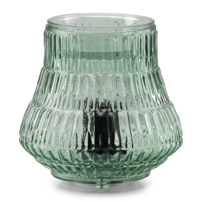 Decorative glass lantern with ribbed texture on a green background