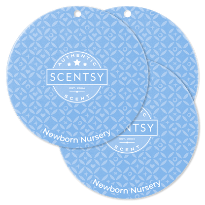Two blue Scentsy Newborn Nursery scented product packaging on a black background