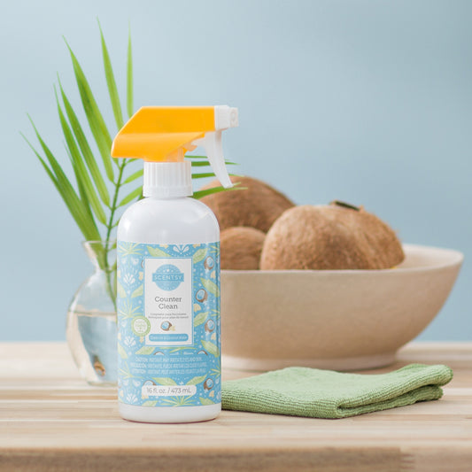 Cleaning spray bottle with a plant and coconuts in the background