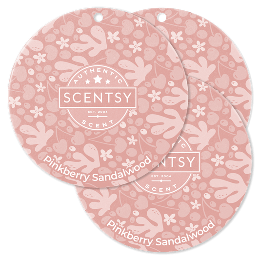 Two Scentsy Pinkberry Sandalwood scented wax discs on a black background