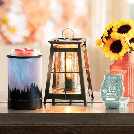 Decorative items including a Scentsy warmer, lantern, and sunflower arrangement on a surface.