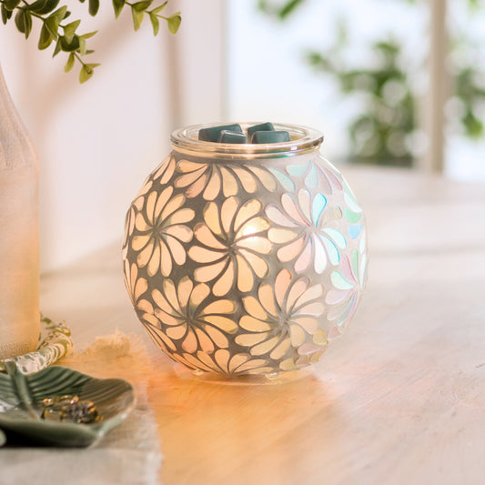 Decorative wax warmer with floral design on a table