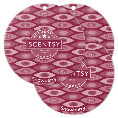 Two Scentsy Snowberry scented wax discs with a patterned design on a black background.