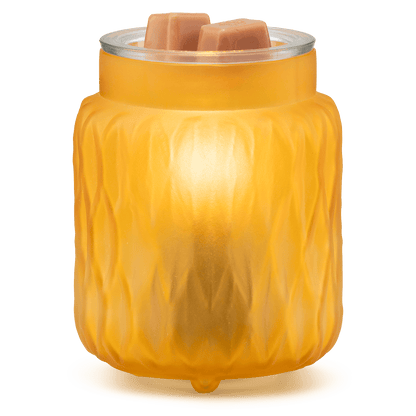 Yellow textured wax warmer with two wax melts on a green background