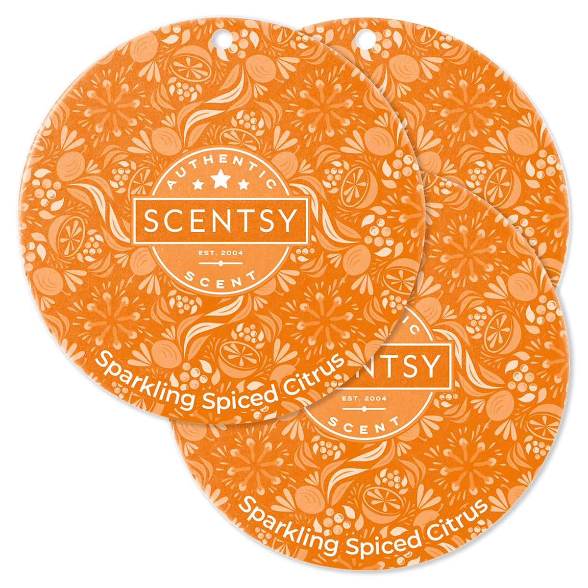 Two Scentsy Sparkling Spiced Citrus scented wax melts on a green background