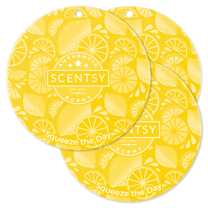 Two yellow Scentsy scent discs with lemon pattern on a black background