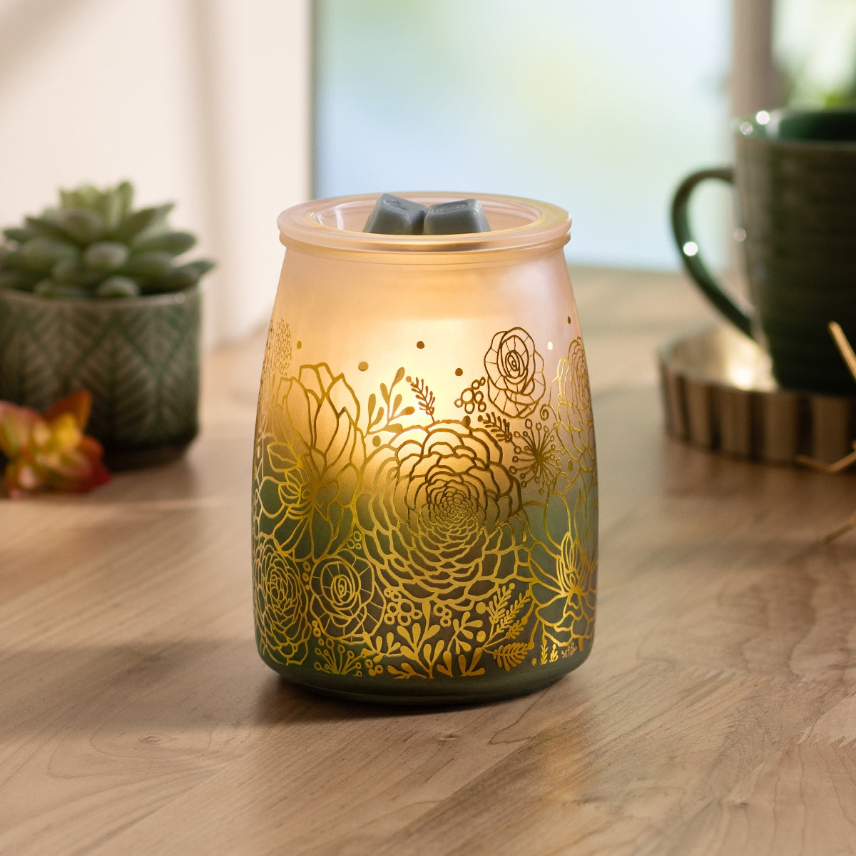Decorative wax warmer with floral patterns on a wooden surface