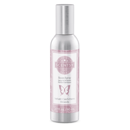 Scentsy room spray bottle with pink label on a green background