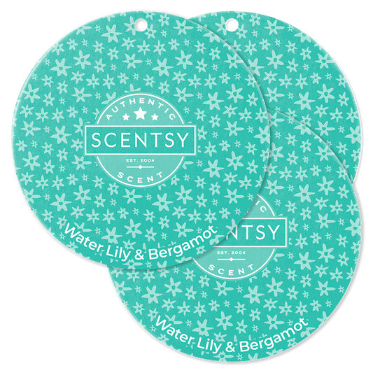 Two Scentsy scent discs with a floral pattern on a green background