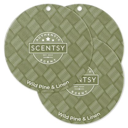 Two Scentsy Wild Pine & Linen scented wax melts on a green background
