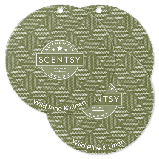 Two Scentsy Wild Pine & Linen scented wax melts on a green background