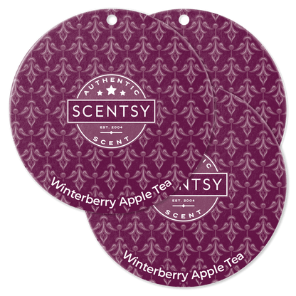 Two Scentsy Winterberry Apple Tea scented discs on a black background