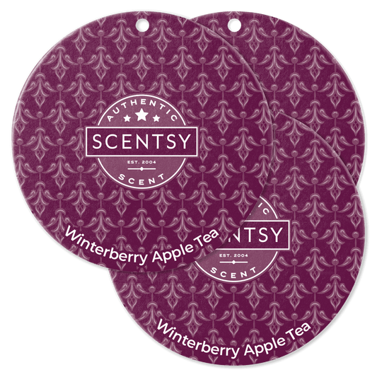 Two Scentsy Winterberry Apple Tea scented discs on a black background