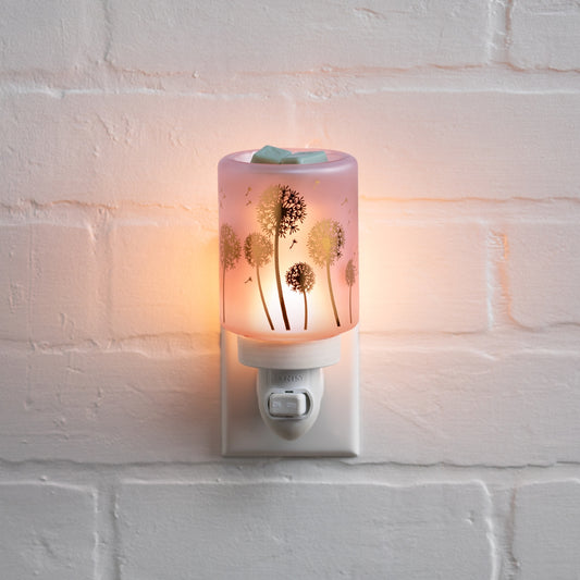 Decorative night light with dandelion design on a white brick wall