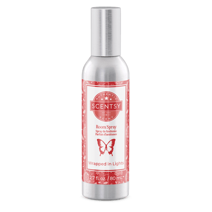 Scentsy room spray bottle with red label on a green background