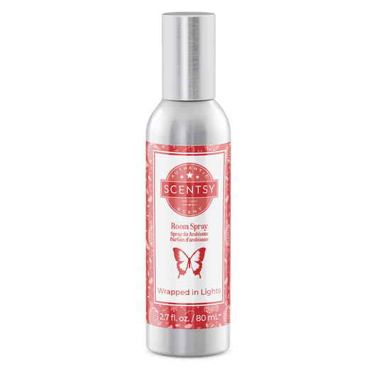 Scentsy room spray bottle with red label on a green background