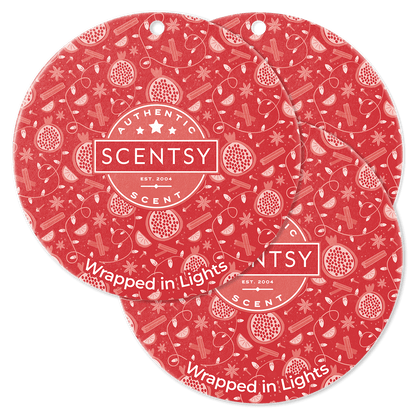 Two Scentsy scented wax product packaging with a red pattern on a green background